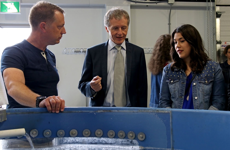 Trevor Pitcher, Alan Wildeman and graduate Tina Suntres examine a tank housing the invasive sea lamprey at the grand opening of the Freshwater Restoration Ecology Centre.