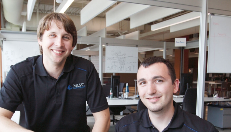  Recent graduates Matthew Lapain and Vincent Colussi are shown working at the Epic Innovation office in the Joyce Entrepreneurship Centre at the University of Windsor.