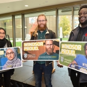 UWindsor students Amal Siddiqui, Max Arvidsson, and David Adelaja pose with mock-ups of billboards bearing their images as part of the Windsor Proud campaign